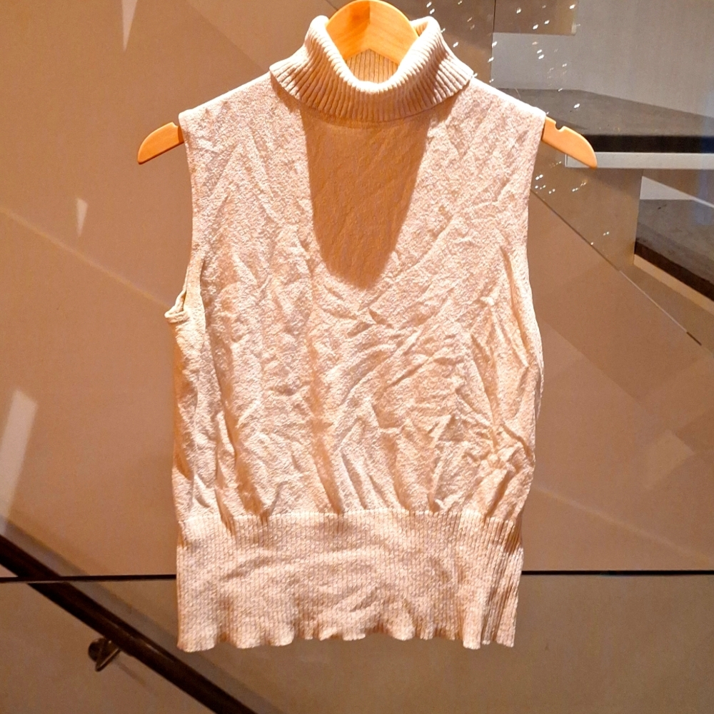 Cream sleeveless turtleneck